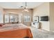 Spacious bedroom features a ceiling fan, and large windows with shutters allowing plenty of natural light at 7690 Blue Whirlpool St, Las Vegas, NV 89131