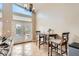 Bright dining area features tiled flooring, a small table, and French doors leading to the outside at 7690 Blue Whirlpool St, Las Vegas, NV 89131