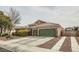 Single-story home featuring a three-car garage, tile roof, desert landscaping, and RV parking at 7690 Blue Whirlpool St, Las Vegas, NV 89131