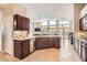 Open kitchen with stainless steel appliances, granite countertops, and view of dining area and living room at 7690 Blue Whirlpool St, Las Vegas, NV 89131