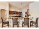 Open kitchen with granite countertops, stainless steel appliances, and breakfast bar seating at 7690 Blue Whirlpool St, Las Vegas, NV 89131
