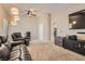 Cozy living room features neutral walls, carpet floors, a ceiling fan, and a tv at 7690 Blue Whirlpool St, Las Vegas, NV 89131