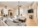Open-concept living room with tile flooring, a fireplace, and a ceiling fan at 7690 Blue Whirlpool St, Las Vegas, NV 89131