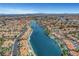 Wide angle aerial showcases homes nestled along a scenic lake with boat docks and lush landscaping at 8132 Bay Harbor Dr, Las Vegas, NV 89128