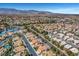 Neighborhood aerial view with homes featuring terra cotta roofs, solar panels, and community lake at 8132 Bay Harbor Dr, Las Vegas, NV 89128