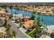 An aerial view shows a waterfront community with palm trees, pools, and terracotta tile roofs at 8132 Bay Harbor Dr, Las Vegas, NV 89128