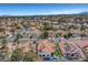 Stunning aerial view of a vibrant community featuring terra cotta-roofed homes, desert landscaping, and waterfront scenery at 8132 Bay Harbor Dr, Las Vegas, NV 89128