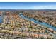 Wide angle aerial showcases homes nestled along a scenic lake and boat docks at 8132 Bay Harbor Dr, Las Vegas, NV 89128