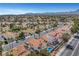 Gorgeous aerial view showcasing terra cotta-roofed homes and desert landscaping in a vibrant community with a waterfront view at 8132 Bay Harbor Dr, Las Vegas, NV 89128