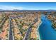 Overhead view of a neighborhood with interconnected lakes, backyard pools, and manicured landscaping at 8132 Bay Harbor Dr, Las Vegas, NV 89128