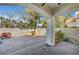 Covered patio overlooking a backyard with rock feature, green hose and drought-tolerant landscaping at 8132 Bay Harbor Dr, Las Vegas, NV 89128