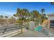 Balcony view with a glimpse of the pool and tiled roof, showcasing mature trees and greenery at 8132 Bay Harbor Dr, Las Vegas, NV 89128