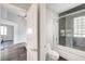 Bathroom featuring a shower and tub combo, gray accent tiles and glass block window at 8132 Bay Harbor Dr, Las Vegas, NV 89128