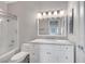 Bright bathroom featuring a tub-shower, white vanity with marble countertop, and neutral wall paint at 8132 Bay Harbor Dr, Las Vegas, NV 89128