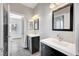 Modern bathroom featuring dual sinks, black framed mirrors and updated fixtures and finishes at 8132 Bay Harbor Dr, Las Vegas, NV 89128