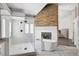 Modern bathroom features a standalone tub, glass shower, and decorative stone accent wall at 8132 Bay Harbor Dr, Las Vegas, NV 89128