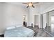 Bedroom featuring gray walls, hard surface floors, ceiling fan and a mirrored sliding closet at 8132 Bay Harbor Dr, Las Vegas, NV 89128