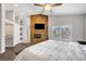 Bedroom boasts a unique stone accent wall and a cozy fireplace for ultimate relaxation at 8132 Bay Harbor Dr, Las Vegas, NV 89128