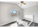 Bedroom featuring a window, ceiling fan, and dark, wood-look flooring at 8132 Bay Harbor Dr, Las Vegas, NV 89128
