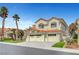 Stunning two-story home showcasing a three-car garage, desert landscaping, and a classic red tile roof at 8132 Bay Harbor Dr, Las Vegas, NV 89128