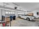 A spacious garage is shown with two cars, bikes and storage cabinets at 8132 Bay Harbor Dr, Las Vegas, NV 89128