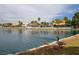 Scenic lake view with waterfront homes, palm trees, and wildlife enjoying the calm water at 8132 Bay Harbor Dr, Las Vegas, NV 89128