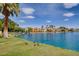 Lake view featuring homes with private docks and lush vegetation along the water's edge at 8132 Bay Harbor Dr, Las Vegas, NV 89128