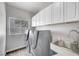 Well-equipped laundry room with modern machines, sink and cabinet at 8132 Bay Harbor Dr, Las Vegas, NV 89128