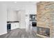 Open living space with fireplace, a wet bar, and a bright kitchen at 8132 Bay Harbor Dr, Las Vegas, NV 89128