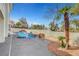 Backyard pool with a waterfall feature, complemented by mature landscaping and rock accents at 8132 Bay Harbor Dr, Las Vegas, NV 89128