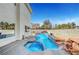Inviting backyard oasis with a sparkling pool, hot tub, and lush landscaping for ultimate relaxation at 8132 Bay Harbor Dr, Las Vegas, NV 89128