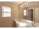 Bathroom featuring double sink vanity and a large mirror with vanity lighting at 9849 Ridge Hill Ave, Las Vegas, NV 89147