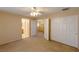 Bright bedroom featuring carpeted flooring, a ceiling fan, and a double door closet at 9849 Ridge Hill Ave, Las Vegas, NV 89147