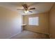 Bedroom with tan carpet, ceiling fan, window, and workstation at 9849 Ridge Hill Ave, Las Vegas, NV 89147