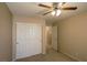 Bedroom featuring carpeted floors, ceiling fan, and double door closet for storage at 9849 Ridge Hill Ave, Las Vegas, NV 89147