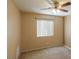 Bedroom with carpeted floors, ceiling fan, and large window bringing in natural light at 9849 Ridge Hill Ave, Las Vegas, NV 89147