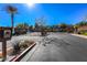 Community entrance features a secured gate and desert landscaping at 9849 Ridge Hill Ave, Las Vegas, NV 89147