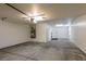 Large, unfinished garage with storage, water heater, and access to a side yard or house at 9849 Ridge Hill Ave, Las Vegas, NV 89147