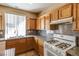 Traditional kitchen with light wood cabinets, granite counters, and tile flooring at 9849 Ridge Hill Ave, Las Vegas, NV 89147
