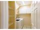 A conveniently located laundry room with a washer, dryer, shelving, and storage cabinets at 9849 Ridge Hill Ave, Las Vegas, NV 89147