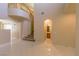 Open-concept living area showcasing tile floors, staircase, and arched entryway at 9849 Ridge Hill Ave, Las Vegas, NV 89147