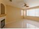 Inviting living room featuring tile floors, ceiling fan, and a fireplace at 9849 Ridge Hill Ave, Las Vegas, NV 89147