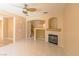 Inviting living room with fireplace and tile flooring with stairs to the second floor in the background at 9849 Ridge Hill Ave, Las Vegas, NV 89147
