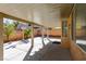 Covered back patio with concrete pad and view of block fence and desert landscaping at 9849 Ridge Hill Ave, Las Vegas, NV 89147