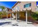 Back patio features a large concrete pad and desert landscaping at 9849 Ridge Hill Ave, Las Vegas, NV 89147
