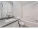 Bright bathroom featuring a shower-tub combo with white tile and a vanity with stone countertop at , Las Vegas, NV 89156