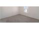 Bright bedroom featuring neutral decor, plush gray carpeting, and a window at , Las Vegas, NV 89156