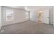 Bright main bedroom featuring plush gray carpeting, two windows, and access to the ensuite bathroom at , Las Vegas, NV 89156