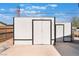 Exterior view of a white shed with black trim, providing ample outdoor storage space at , Las Vegas, NV 89156