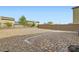 Large backyard with gravel landscaping, brick-paved patio, and privacy fence at 4454 Lantern Point Ave, North Las Vegas, NV 89084